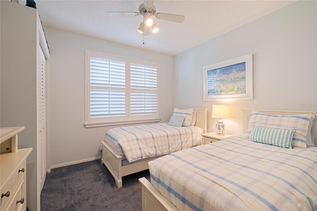 bedroom featuring baseboards, ceiling fan, and dark carpet