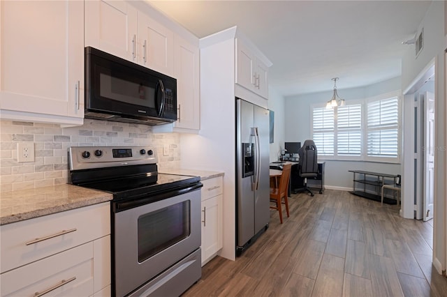 kitchen with visible vents, wood finished floors, appliances with stainless steel finishes, white cabinets, and decorative backsplash