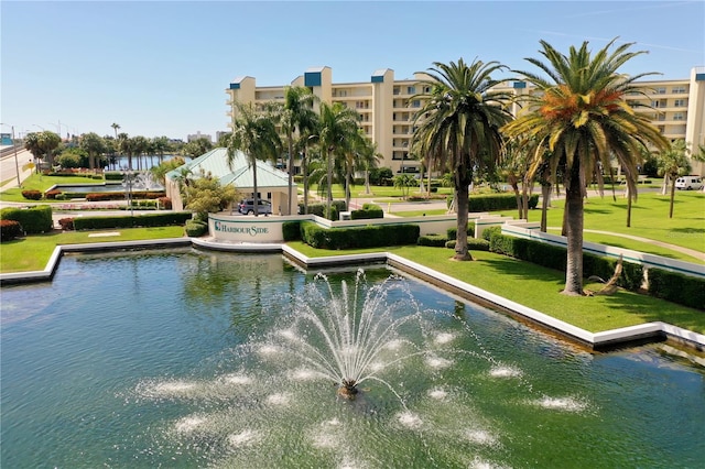 view of community with a water view and a lawn