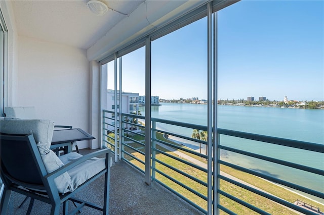 sunroom / solarium featuring a water view