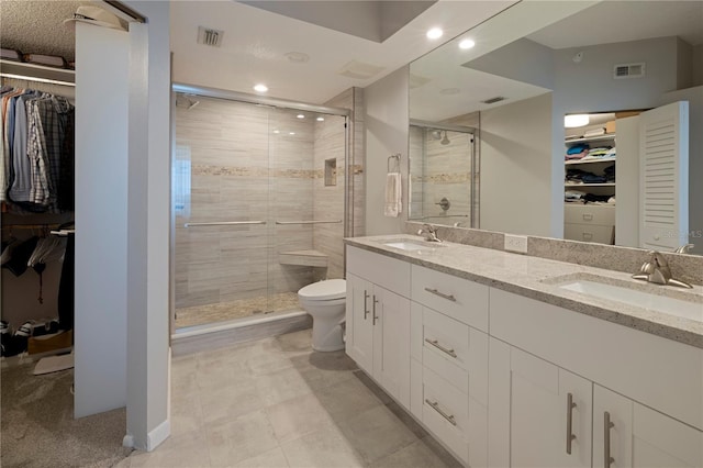 full bath featuring a shower stall, recessed lighting, toilet, and a spacious closet
