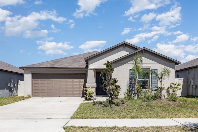 view of front facade featuring a garage, driveway, and stucco siding