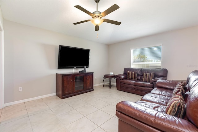 living room with light tile patterned floors, baseboards, and a ceiling fan