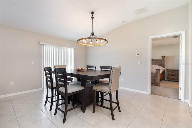 dining room featuring light tile patterned flooring, baseboards, visible vents, and a chandelier