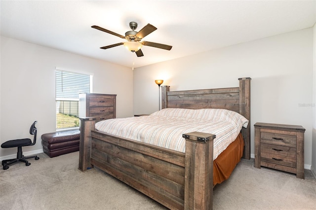 bedroom featuring ceiling fan, baseboards, and light carpet