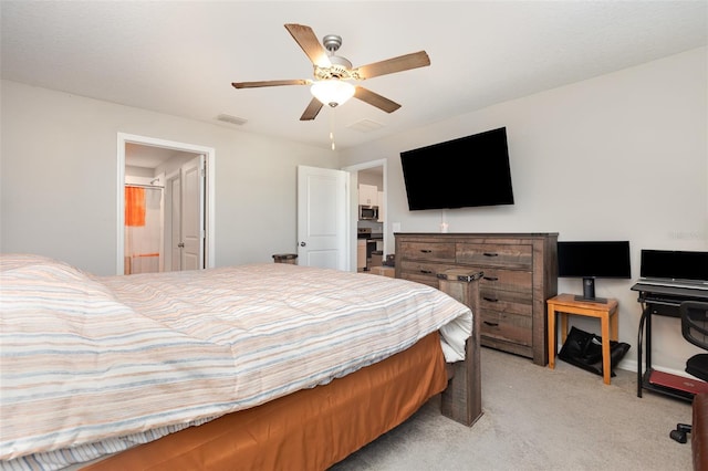 bedroom featuring visible vents, light colored carpet, ensuite bath, and a ceiling fan