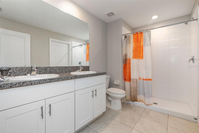 full bathroom with a sink, toilet, a stall shower, and tile patterned flooring