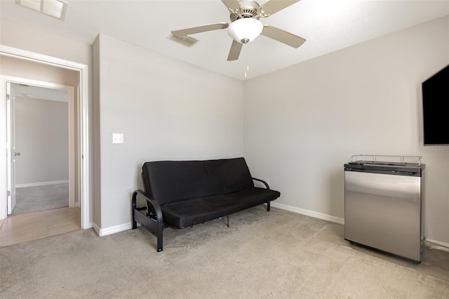 sitting room with baseboards, carpet flooring, a ceiling fan, and visible vents