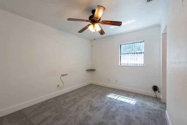 carpeted empty room with crown molding, baseboards, and ceiling fan