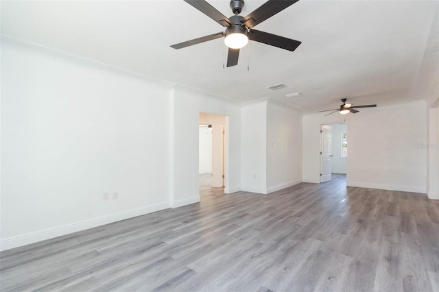 unfurnished room with light wood-type flooring, baseboards, and a ceiling fan