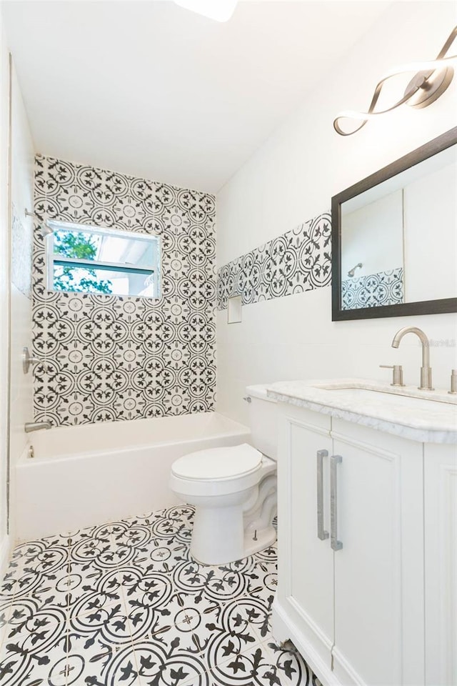 bathroom with tile patterned floors, bathing tub / shower combination, toilet, and vanity