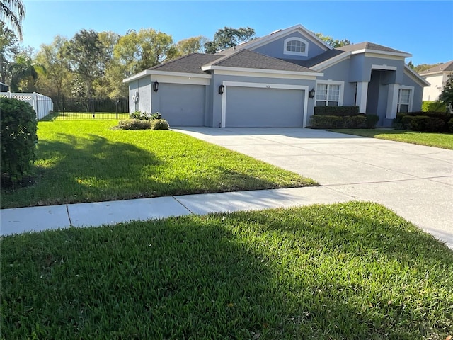 view of front of house featuring a garage, driveway, a front yard, and stucco siding