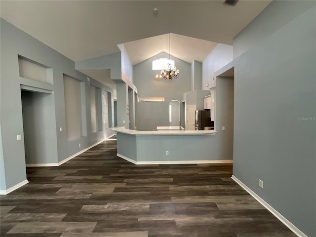 kitchen featuring a notable chandelier, white cabinetry, freestanding refrigerator, and dark wood-type flooring