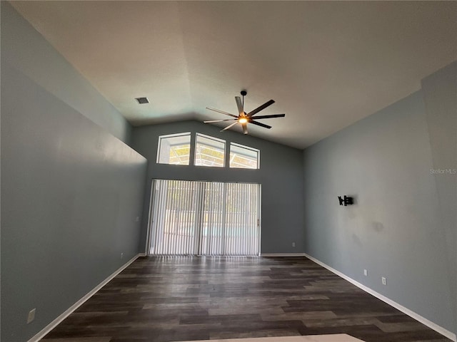 empty room with wood finished floors, a ceiling fan, baseboards, and lofted ceiling