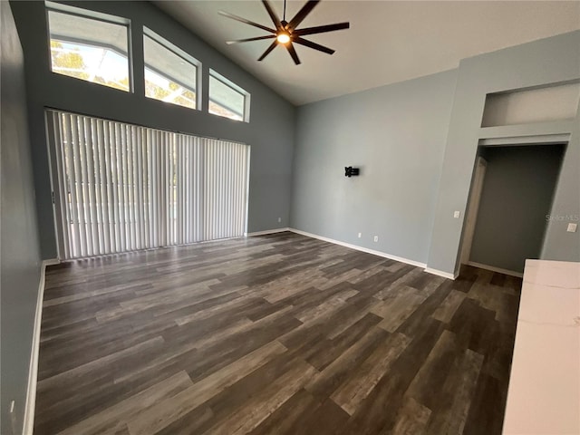 unfurnished living room with baseboards, lofted ceiling, wood finished floors, and a ceiling fan