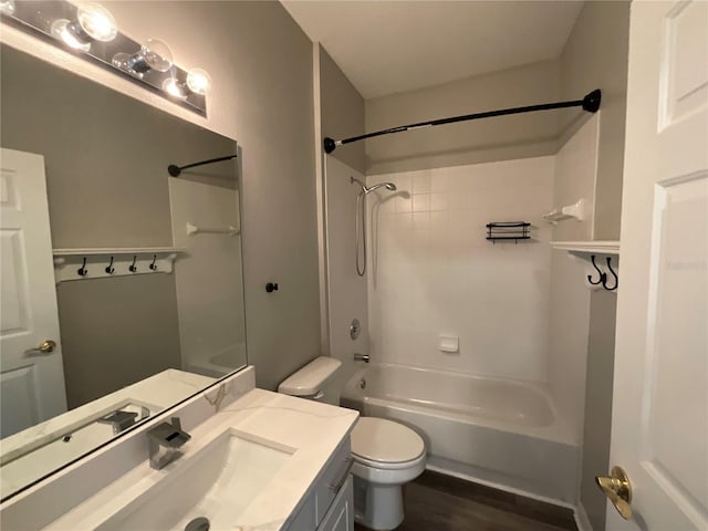 bathroom with vanity, toilet, shower / tub combination, and wood finished floors