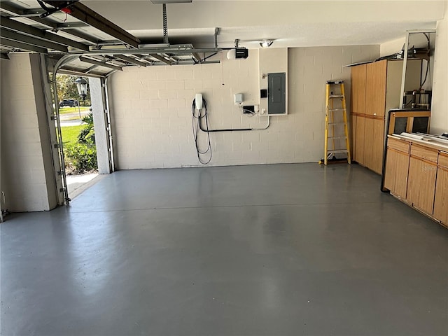 garage with electric panel and concrete block wall