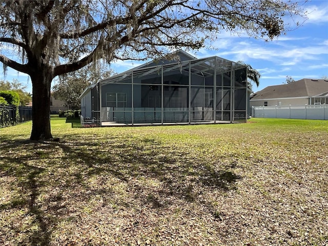 view of yard with a lanai and a fenced backyard