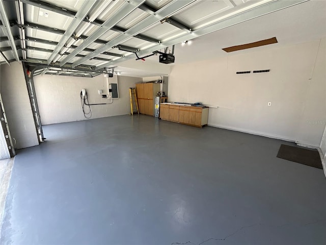 garage featuring electric panel, electric water heater, and a garage door opener