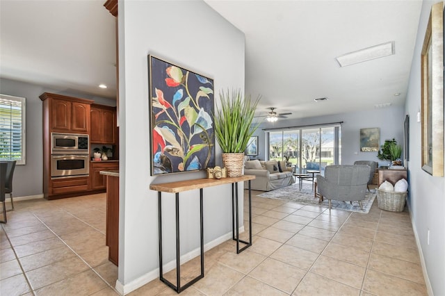 interior space with a wealth of natural light, baseboards, and light tile patterned flooring