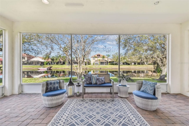 sunroom / solarium with a water view