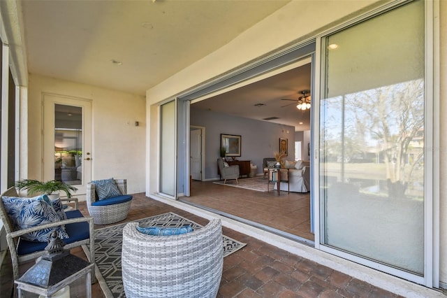 sunroom featuring ceiling fan