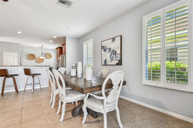 dining room with light tile patterned floors, visible vents, recessed lighting, and baseboards