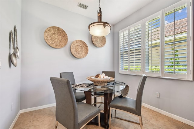 dining area with tile patterned floors, baseboards, and visible vents