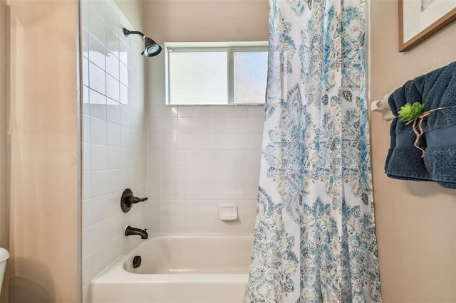 full bath with toilet and shower / bath combo with shower curtain