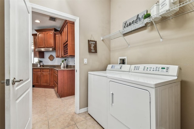 laundry area featuring light tile patterned floors, visible vents, laundry area, and washing machine and clothes dryer