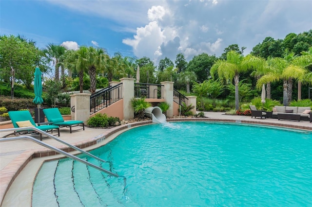 community pool featuring outdoor lounge area, a patio, and stairway