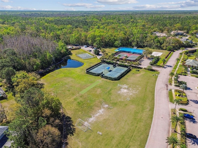 aerial view featuring a view of trees and a water view