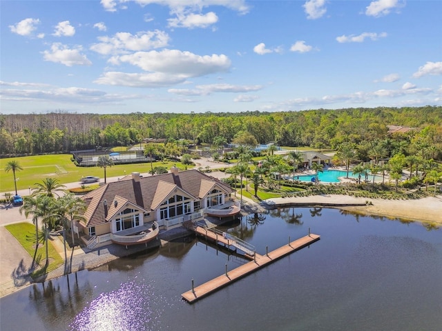 drone / aerial view with a forest view and a water view