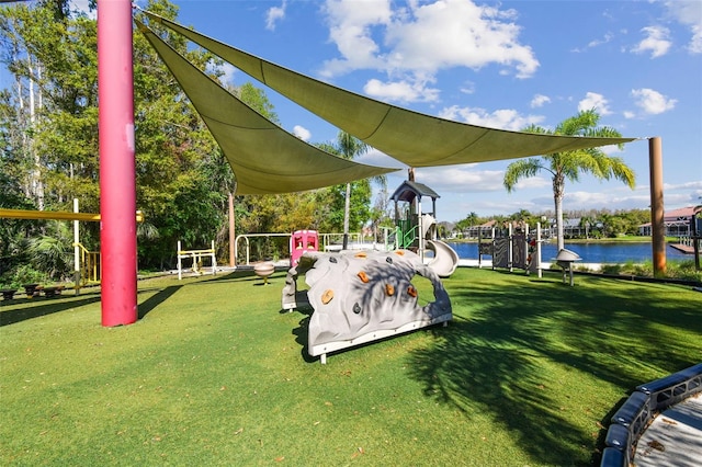 view of home's community with a lawn and a water view