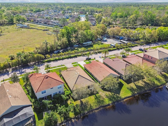 drone / aerial view featuring a residential view and a water view