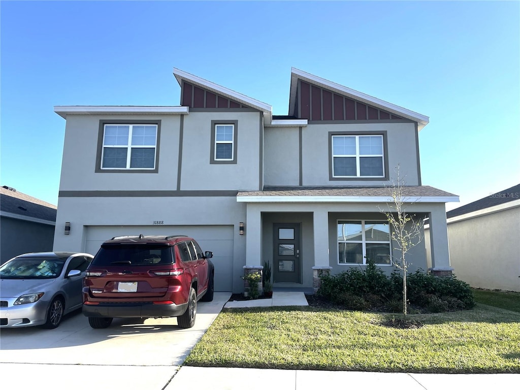 view of front facade featuring stucco siding, board and batten siding, concrete driveway, and an attached garage