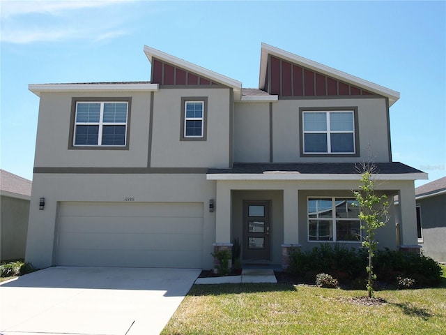 31888 Treasure Dock Isle, Wesley Chapel, FL 33545 - view of front of property featuring driveway, an attached garage, board and batten siding, and stucco siding