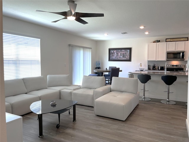 31888 Treasure Dock Isle, Wesley Chapel, FL 33545 - living room with recessed lighting, ceiling fan, light wood-style flooring, and visible vents