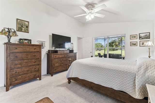 bedroom featuring light carpet, a ceiling fan, and lofted ceiling