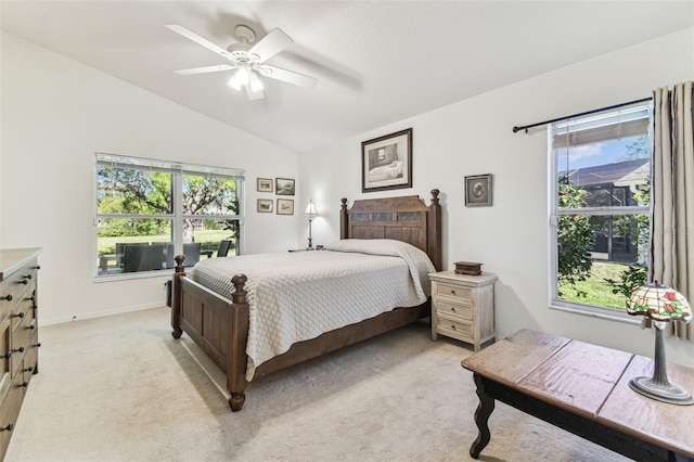 bedroom featuring lofted ceiling, multiple windows, and light colored carpet