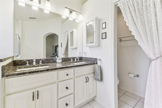 full bath with a sink, visible vents, toilet, and tile patterned flooring