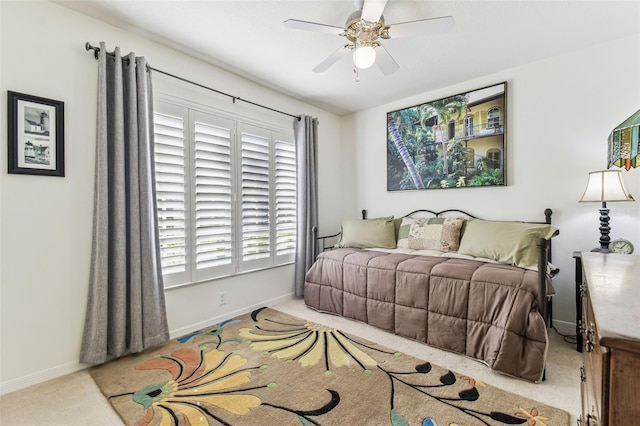 carpeted bedroom with baseboards and ceiling fan