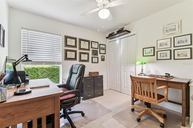 home office with a ceiling fan and light colored carpet