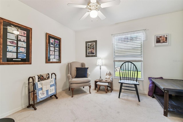 sitting room with baseboards, carpet floors, and ceiling fan