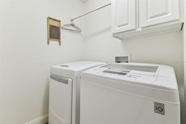 laundry room featuring washing machine and dryer and cabinet space