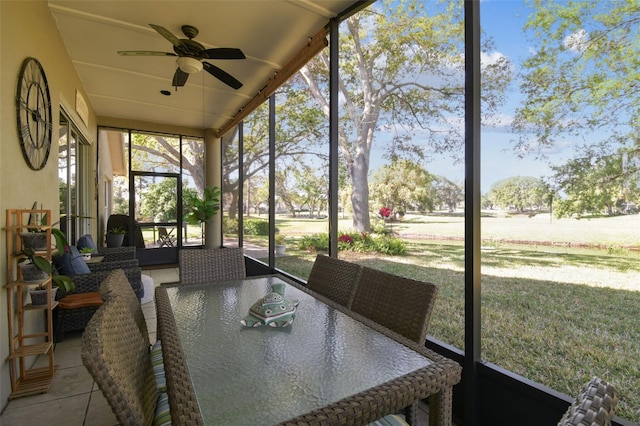 sunroom featuring ceiling fan