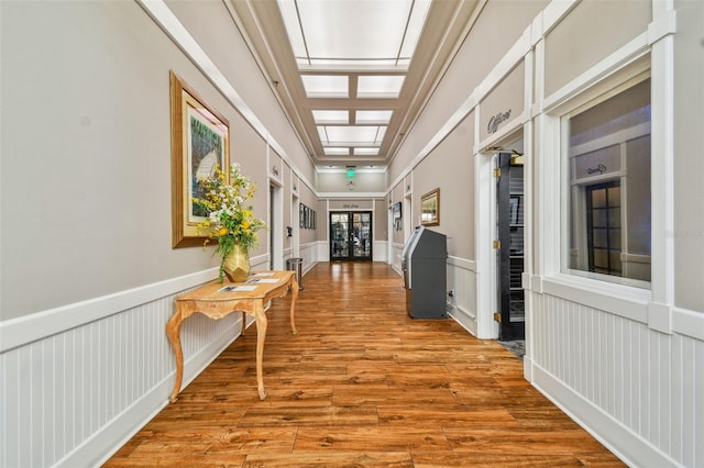 hallway with wainscoting and wood finished floors