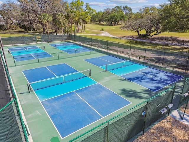 view of sport court featuring fence