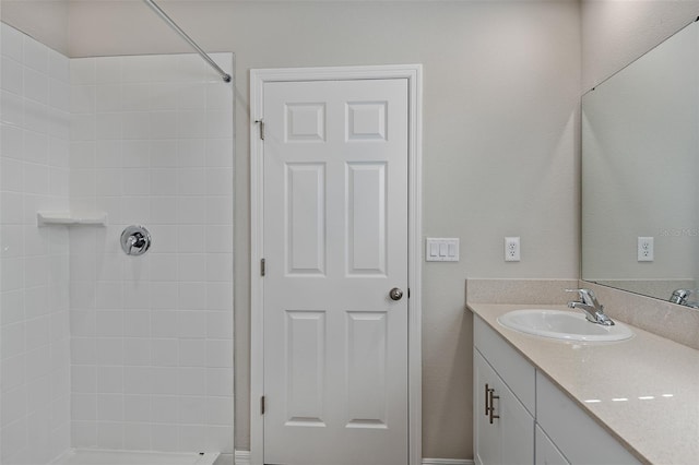 full bathroom with vanity and tiled shower