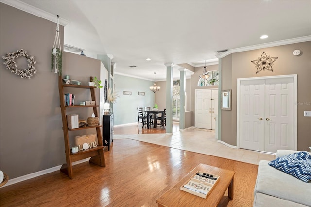 living area with light wood-type flooring, visible vents, crown molding, baseboards, and ornate columns